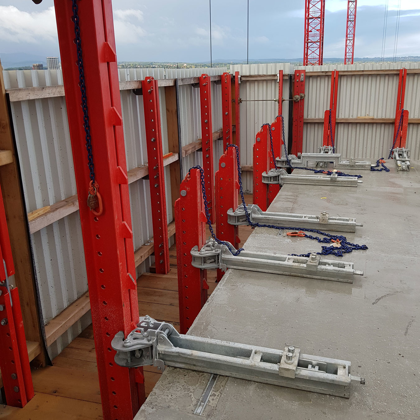 A rail guided formwork system attached to concrete