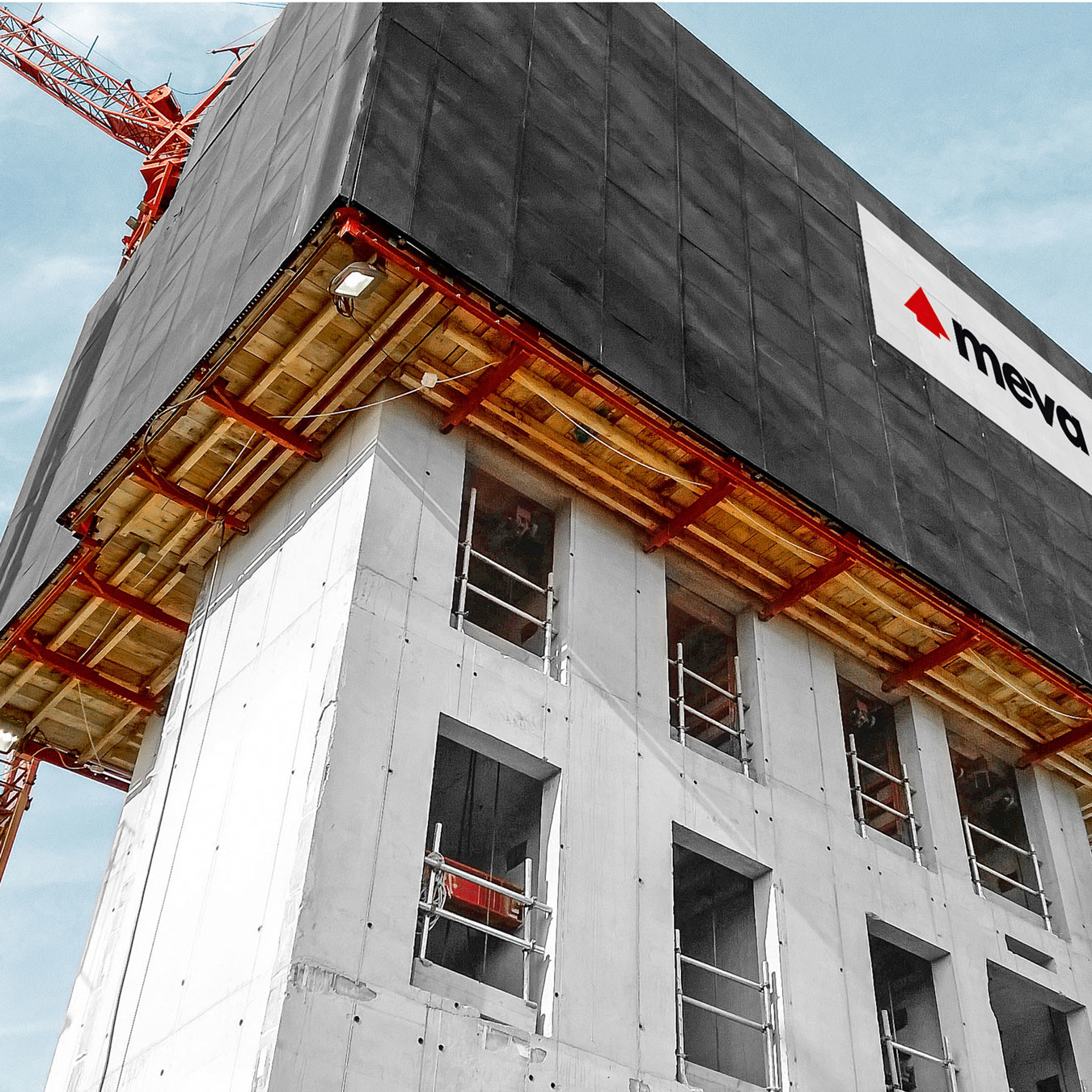 Automated climbing formwork system attached to a high rise building under construction