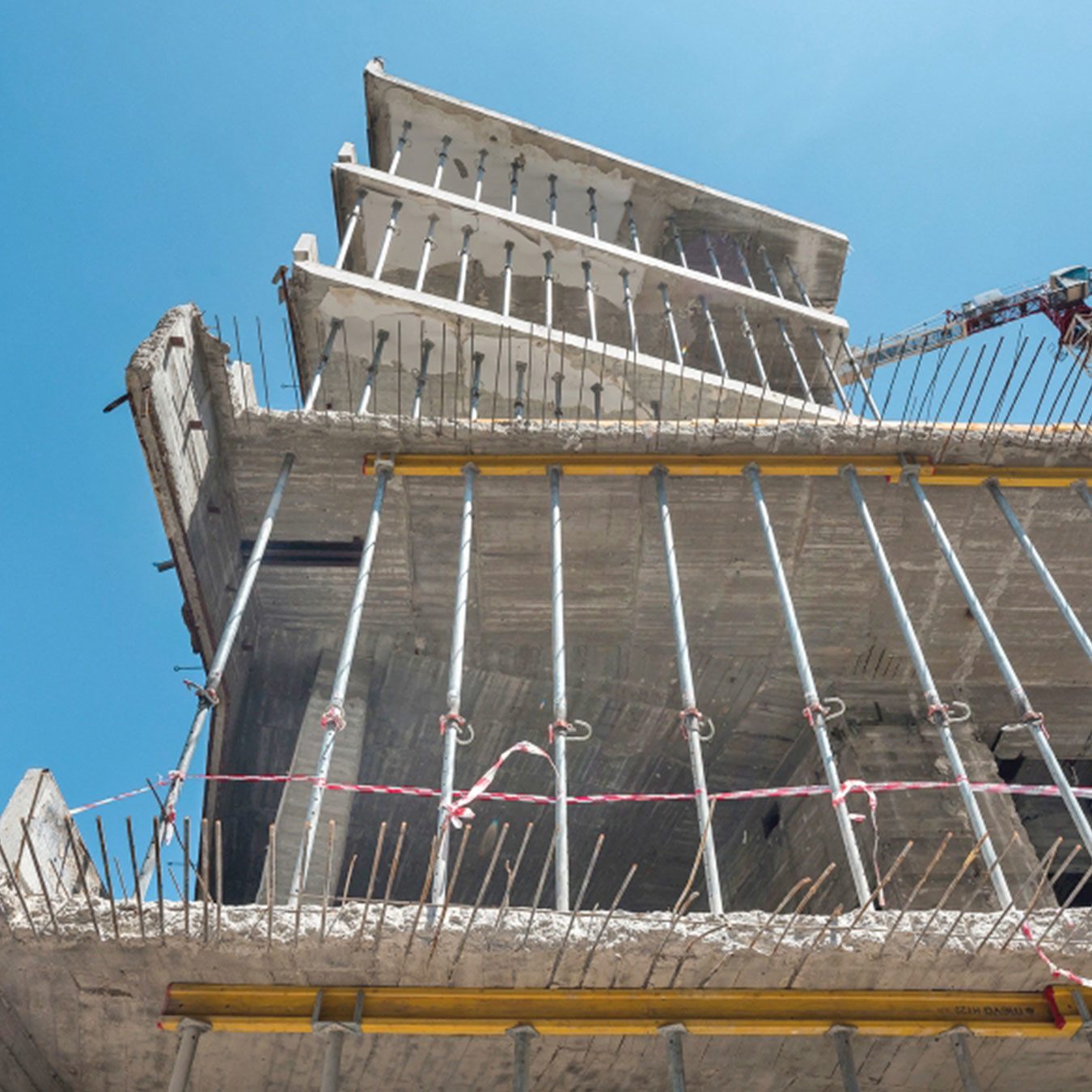 Props being used to hold concrete floors of a building under construction