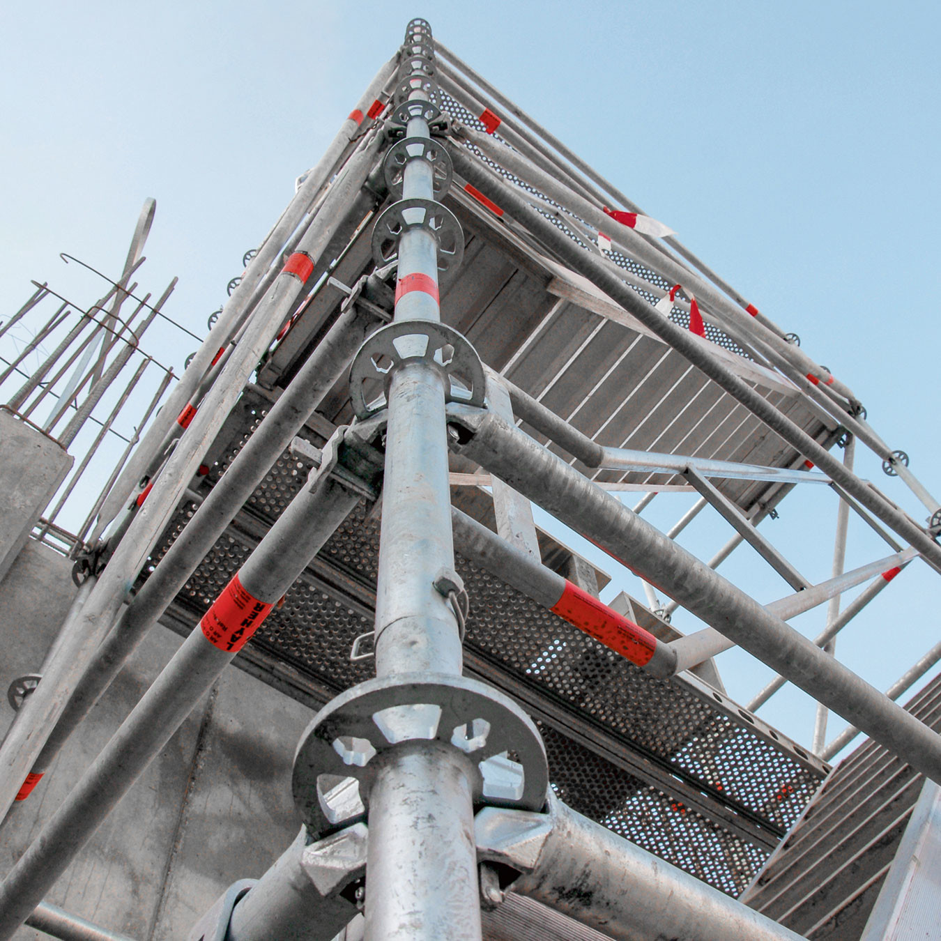 Looking up at a shoring tower attached to a concrete wall