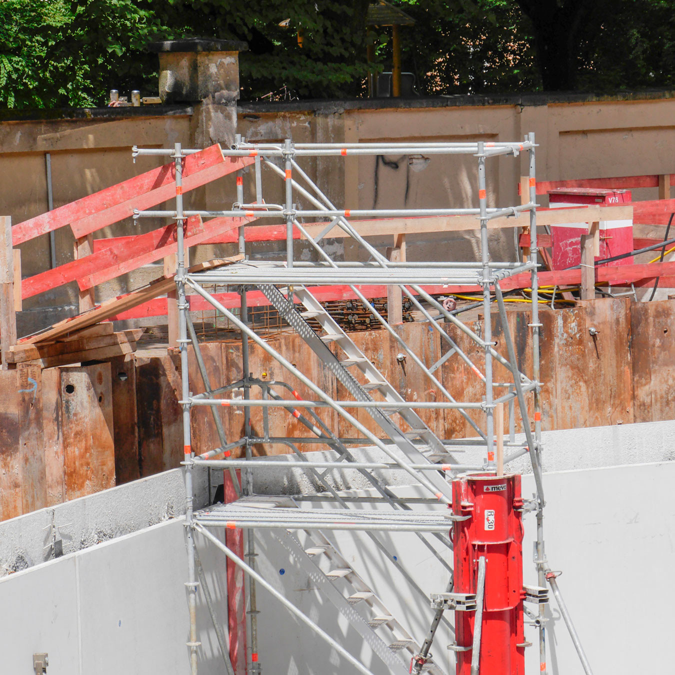 Looking up at a shoring tower attached to a concrete wall
