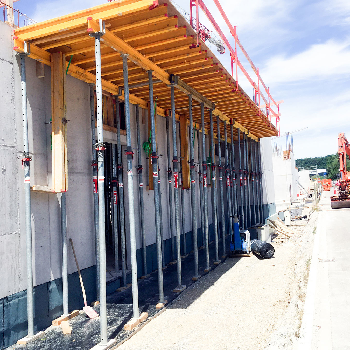 Slab formwork system attached to concrete building