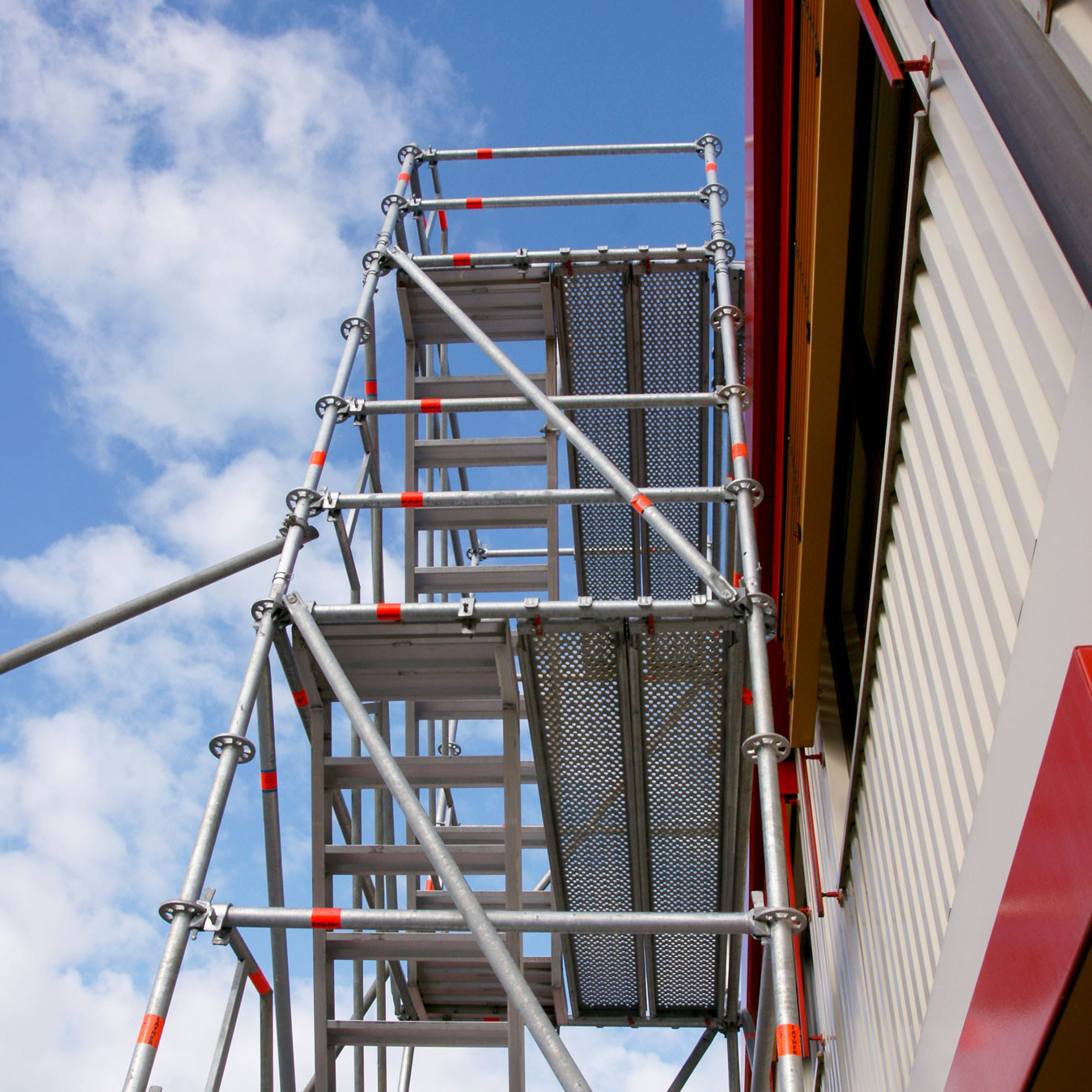 Looking up at a shoring tower attached to a concrete wall